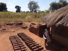 Brick making just outside of her home